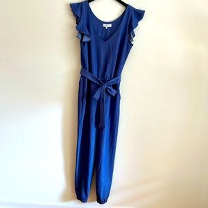 Denim, lightweight jumpsuit with pockets and waistband tie. Perfect fall look.